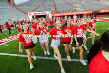 Students cheer after running onto the field in Memorial Stadium during the Tunnel Walk, before linin