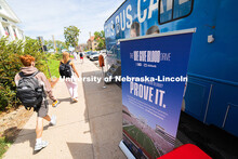 Students walk by a Nebraska Community Blood Bank bus during the first campus blood drive of the year