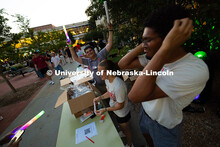 Gavin Moore (right) and Nicholas Mele (left) dance to music from speakers behind them as Haylie Hoat