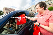 Dee Dee Anderson, Vice Chancellor for Student Life, hands swag bags to Jessica Longacre and her room