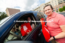 Dee Dee Anderson, Vice Chancellor for Student Life, hands swag bags to Jessica Longacre and her room