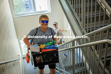 Isaac Olsen carries a crate up to his dorm room on move-in day in Massengale Hall. Residence hall mo