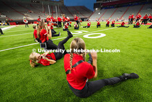 Piccolo players sit in goofy positions for a silly rendition of "There is No Place Like Nebraska" du