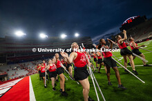 Color guard members dance out of Memorial Stadium after the band exhibition. Cornhusker Marching Ban