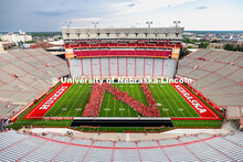Freshman students form an N on the Memorial Stadium field for the class of 2029 photo during the 202