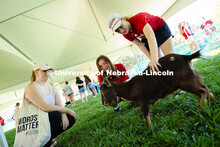 Students pet a goat from Shepherd's Rest after one of the Goat Yoga sessions held as part of the Wel