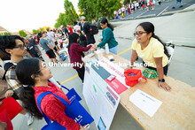 First-year students Angella Nguyen and Alex Cancino learn about the UNL Badminton Club from Praneeth
