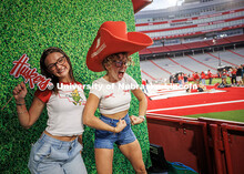 Camille Andelt (left) and Hallie Clarke pose at the photo booth for the Nebraska vs. Cincinnati foot