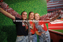 Sierra Rasmussen (left), Hailey Haynes and Claire Lalim pose at the photo booth for the Nebraska vs.