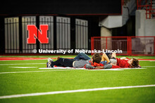 Students lay on the turf while watching Nebraska vs. Cincinnati football game at the watch party in 