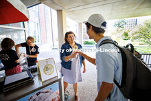 Elizabeth Lorang, the Dean of University Libraries, hands an ice cream cone to Yakub Islamov, a seni