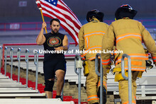 Jean Delgado, a Lincoln resident and Marines veteran, runs by two Lincoln Fire and Rescue members on