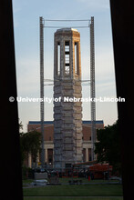 Morning sunlight touches Mueller Tower's exposed brick as scaffolding supports surround it as constr