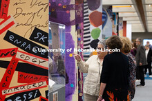 Visitors view “The Muck, the Seeds, the Weeds, the Blossoming: The Journals of Karen Blessen,” a
