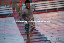 Army ROTC cadets spring up the steps in Memorial Stadium. ROTC cadets and midshipmen run 110 flights