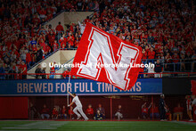 A spirit squad member runs with the oversized N flag in the end zone after a touchdown during the Ne