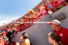 Husker fans look up as members of the student section do pushups, one for each touchdown scored agai