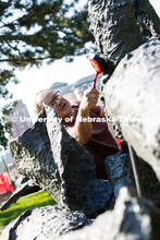 Les Bruning, owner of Bruning Sculpture in Omaha, uses a brush to remove dust and debris from Ruben 