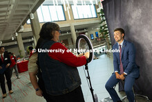 Max Muller, a junior studying agronomy, poses in front of a backdrop for a portrait during the caree