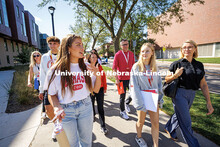Sophomore, Arihanna Marlatt (left), leads a tour group past Caroline Pope Edwards Hall on Red Letter