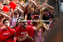 A student bearing cornstalks cheers from the student section during the game. Nebraska vs. Michigan 
