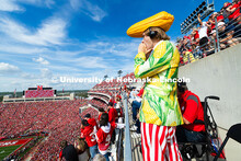 Jordan Kouma, a student at Southeast Community College, cheers from the top of east stadium as the H