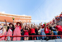 Students wave their arms back and forth at the tail end of the football game. Nebraska vs. Michigan 