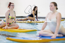 Alexa Schell, center, junior Child, Youth and Family Studies major, participates in Paddleboard Yoga