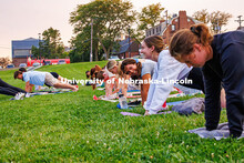 Students laugh as they hold a plank during the Pilates Pop-Up event held by Campus Rec at the 17th S