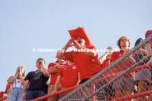 A student with a giant Herbie hat cheers in the student section. Nebraska vs Michigan State football