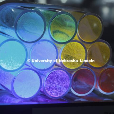 Tubes of various solar-powered catalysts glow in a rainbow of colors under ultraviolet light. Jian Zhang, assistant professor of chemistry, recently earned a five-year, $527,154 Faculty Early Career Development Program Award from the National Science Foundation to develop an organic-based catalyst that uses the sun’s energy to facilitate chemical reactions. His work could one day lead to cleaner fuel production. March 10, 2016. Photo by Craig Chandler / University Communications.