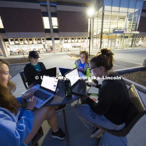 On nice evenings, the studying spills out to the new plaza. Mary Benes, Kelsey Rouse, Christina Coon and Michaela Daugherty work on their education project. Adele Hall Learning Commons in North Love Library,  April 12, 2016.  Photo by Craig Chandler / University Communications