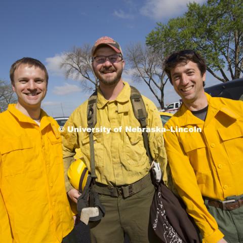 Carrick Detweiler, left, Dirac Twidwell and Sebastian Elbaum  before the controlled burn. Controlled burn at the Homestead National Monument in Beatrice, NE. Sebastian Elbaum and Carrick Detweiler have engineered a drone able to light controlled prairie burns using balls dropped from the sky. The drone injects a liquid into the plastic spheres to start a delayed fiery process so the balls can fall to the ground before igniting. Elbaum and Detweiler are Professors of computer science and engineering. Twidwell is an assistant professor and range land ecologist in the school of natural resources. April 22, 2015. Photo by Craig Chandler / University Communications