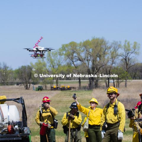 Controlled burn at the Homestead National Monument in Beatrice, NE. Sebastian Elbaum and Carrick Detweiler have engineered a drone able to light controlled prairie burns using balls dropped from the sky. The drone injects a liquid into the plastic spheres to start a delayed fiery process so the balls can fall to the ground before igniting. Elbaum and Detweiler are Professors of computer science and engineering. Twidwell is an assistant professor and range land ecologist in the school of natural resources. April 22, 2015. Photo by Craig Chandler / University Communications