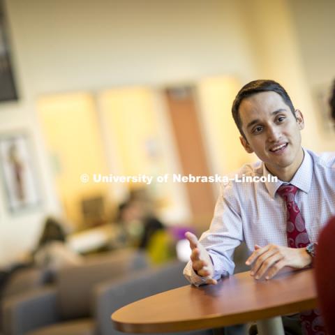 Moises Padilla, Assistant Director of the Office of Academic Success and Intercultural Services (OASIS) talks with a co-worker in the Jackie Gaughan Multicultural Center. January 10, 2017. Photo by Craig Chandler / University Communication.