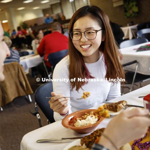 Amy Leiferman, left, and Rong Fan sample lunch Tuesday. The two first-year graduate students in nutrition took a bit of everything and shared to taste it all. It's Fat Tuesday at the East Campus Dining Hall. Chef Ron White, who grew up in uptown New