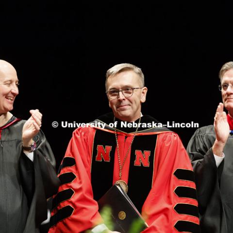 Chancellor Ronnie Green smiles as Nebraska Governor Pete Ricketts and Reverend Gregory Bouvier applaud his speech. Installation Ceremony for Chancellor Ronnie Green. April 6, 2017. Photo by Craig Chandler / University Communication.