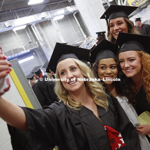 Megan Gould, Kiara Moody. Cassandra Jane Wilka and Courtney Belden take a selfie while waiting for commencement to begin. Students received their undergraduate diplomas Saturday morning in Lincoln's Pinnacle Bank Arena. 2452 degrees were awarded Saturday