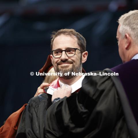Evan Williams, Nebraska native and founder of Twitter, receives an honorary degree before he delivered the Commencement Address "Farm Kid Swipes Fire". Williams is receiving help with his hood from Donde Plowman, Executive Vice Chancellor and Chief