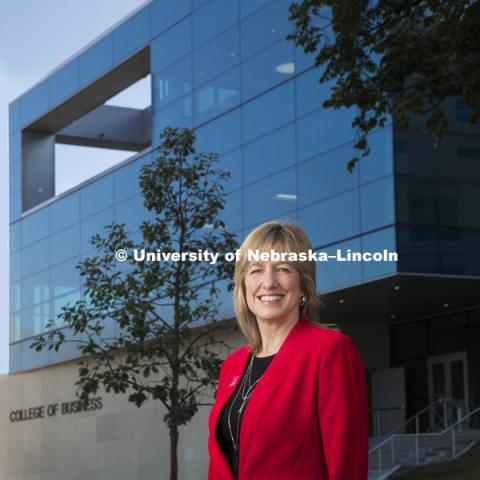 Kathy Farrell, interim Dean of the College of Business. She stands in front of the new building, Hawks Hall, opening in the fall. July 14, 2017. Photo by Craig Chandler / University Communication.