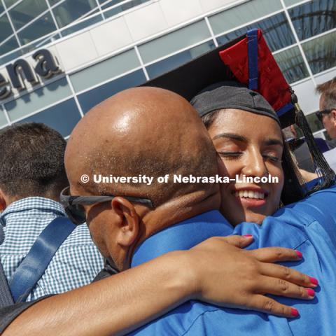 Abi Paudel receives a hug outside Pinnacle Bank Arena following August Commencement. August 12, 2017. Photo by Craig Chandler / University Communication.