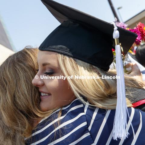 Taylor Kuhlman receives a hug outside Pinnacle Bank Arena following August Commencement. August 12, 2017. Photo by Craig Chandler / University Communication.