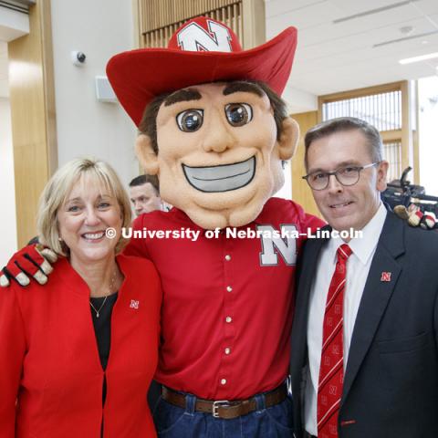 Donde Plowman and Chancellor Ronnie Green pose for a picture with Herbie Husker. Nebraska College of Business is officially "Open for Business" in their new home, Howard L. Hawks Hall. August 18, 2017. Photo by Craig Chandler / University Communication.