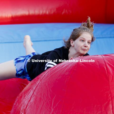 Cassidy Maher bounces after slipping in the Leaps and Bounds, an obstacle course comprised of three inflated balls in an inflatable pit. Back to School Bash on the Nebraska Union Plaza and Green Space sponsored by Campus NightLife. Students enjoyed a