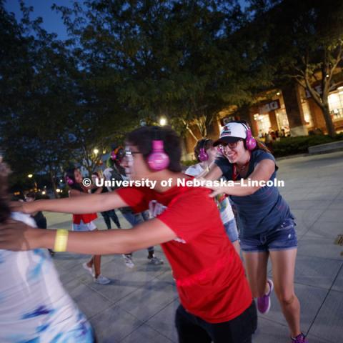 Students dance during the headphone disco party at the Back to School Bash on the Nebraska Union Plaza and Green Space sponsored by Campus NightLife. Students enjoyed a headphone disco party, inflatable games, and refreshments. August 25, 2017. Photo by