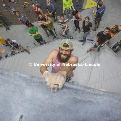 Brad South reaches the top of a climbing path. The League of Extraordinary Boulderers features three-member teams traversing 20 ever-changing routes on the bouldering wall in the Campus Recreation facility on City Campus. The program is designed to teach