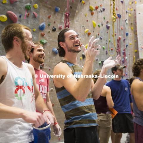 Walter Manchester, Ryan Ossell and Joe Philibert laugh as they discuss their traverse. The League of Extraordinary Boulderers features three-member teams traversing 20 ever-changing routes on the bouldering wall in the Campus Recreation facility on City