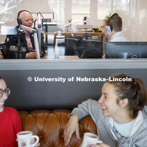 Bryce Doeschot, KRVN Farm Broadcaster and Video Specialist and 2017 UNL graduate, interviews Dan Duncan, Executive Director of Nebraska Innovation Campus, in KRVN's new radio studio in NIC. The studio looks out over the expanded The Mill coffee shop.