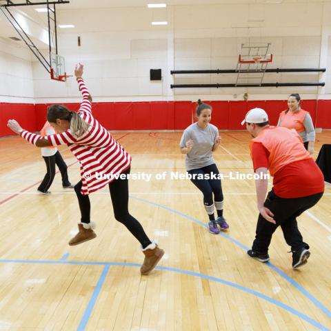 Emily Hetmanek stops before being tagged by Chris Berggren during a game of line tag. Masters students in TEAC 893 Seminar Workshop in Health & Physical Education apply learning principals to physical education games in Mabel Lee hall gymnasium.  January