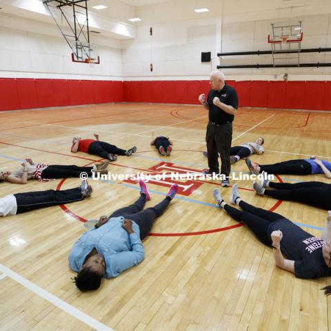 Gary Pence, a retired physical education teacher from Norris school district and lectureer in TLTE, instructs the students in relaxation techniques for their students. Masters students in TEAC 893 Seminar Workshop in Health & Physical Education apply